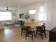Bright, open living room with hardwood floors, modern lighting, and stylish furniture arrangement at 5223 Gray Wolf Ln, Castle Rock, CO 80104