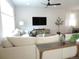 Comfortable living area with a large sectional, hardwood floors, and modern entertainment setup at 5223 Gray Wolf Ln, Castle Rock, CO 80104