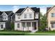 Two-story house with light beige siding, red door, and landscaping at 240 Sassafras St, Erie, CO 80516