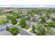 Aerial view of the neighborhood with lush green trees, manicured lawns, and attractive homes at 11188 Latigo Ln, Parker, CO 80138