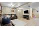 Finished basement featuring a comfortable seating area, mounted TV, and adjacent ' playroom at 11188 Latigo Ln, Parker, CO 80138