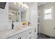 Bathroom featuring double sink vanity with marble countertops and framed mirror, with walk-in glass shower at 11188 Latigo Ln, Parker, CO 80138