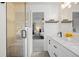 Elegant bathroom featuring walk-in glass shower and double sink vanity with white cabinets and marble countertops at 11188 Latigo Ln, Parker, CO 80138