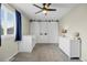 Charming bedroom with carpet and ceiling fan, featuring built in storage with stylish sliding barn doors at 11188 Latigo Ln, Parker, CO 80138