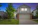 Charming two-story home with a well-maintained lawn and a two-car garage, perfect for Gathering living at 11188 Latigo Ln, Parker, CO 80138