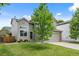 Charming home with well-manicured lawn, beautiful landscaping, and an attached garage at 11188 Latigo Ln, Parker, CO 80138