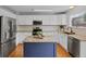Modern kitchen with white cabinets, granite countertops, stainless steel appliances, and a center island at 11188 Latigo Ln, Parker, CO 80138