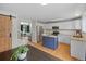Bright and stylish kitchen featuring granite countertops, white cabinetry, and a blue island at 11188 Latigo Ln, Parker, CO 80138