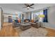 Bright and open living space with hardwood floors connecting the kitchen and seating area at 11188 Latigo Ln, Parker, CO 80138