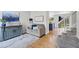 Cozy living room featuring hardwood floors, a comfortable sofa, and staircase access at 11188 Latigo Ln, Parker, CO 80138