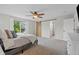 Well-lit main bedroom with carpet and a sliding barn door leading to the en-suite bathroom at 11188 Latigo Ln, Parker, CO 80138
