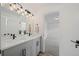 Bathroom features a dual sink vanity, modern fixtures, and view into the bedroom at 1578 Lowell Blvd # 1, Denver, CO 80204