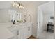 Bathroom features a dual sink vanity, modern fixtures, and view into the office at 1578 Lowell Blvd # 1, Denver, CO 80204