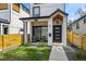 Charming exterior showcasing a modern home with a covered porch and well-maintained landscaping at 1578 Lowell Blvd # 1, Denver, CO 80204