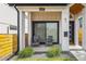 Inviting front porch with seating area, attractive landscaping, and a welcoming entryway at 1578 Lowell Blvd # 1, Denver, CO 80204