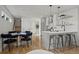Open-concept kitchen and dining area with modern appliances, breakfast bar, and hardwood floors at 1578 Lowell Blvd # 1, Denver, CO 80204