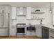 Bright kitchen showcasing stainless steel appliances and modern white cabinetry at 1578 Lowell Blvd # 1, Denver, CO 80204