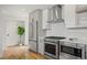 Bright kitchen with stainless steel appliances and white backsplash at 1578 Lowell Blvd # 1, Denver, CO 80204