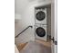 Hall laundry closet features a stacked washer and dryer for space saving convenience at 1578 Lowell Blvd # 1, Denver, CO 80204