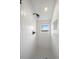 Modern shower with sleek white tiling, a window, and black fixtures at 1578 Lowell Blvd # 1, Denver, CO 80204