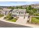 Expansive aerial view of a well-maintained home with a three-car garage and a lush backyard at 2090 Bellavista St, Castle Rock, CO 80109