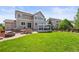 Expansive backyard featuring a lush lawn, outdoor dining set, a hot tub, and a gas firepit at 2090 Bellavista St, Castle Rock, CO 80109