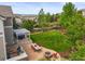 Aerial view of a spacious backyard featuring a fire pit, built-in grill, dining set, and hot tub at 2090 Bellavista St, Castle Rock, CO 80109