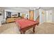 Finished basement features a billiard table, cozy seating area, and a rustic barn door accent at 2090 Bellavista St, Castle Rock, CO 80109