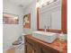 Modern half bathroom showcasing a vessel sink atop a wood vanity with a decorative mirror and elegant fixtures at 2090 Bellavista St, Castle Rock, CO 80109