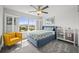 Comfortable bedroom showcasing a plush bed, plantation shutters and an inviting yellow accent chair at 2090 Bellavista St, Castle Rock, CO 80109