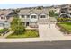 Inviting two-story home featuring a three-car garage, well-manicured lawn, and beautiful landscaping at 2090 Bellavista St, Castle Rock, CO 80109