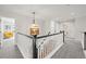 Bright hallway features modern lighting and staircase with contrasting black and white elements at 2090 Bellavista St, Castle Rock, CO 80109