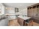 Modern kitchen with stainless steel appliances, an island with marble countertop and barstool seating at 2090 Bellavista St, Castle Rock, CO 80109