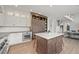 Bright kitchen featuring a center island with a marble countertop and modern cabinetry at 2090 Bellavista St, Castle Rock, CO 80109