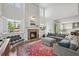Spacious living room with a brick fireplace, large windows, and comfortable seating, perfect for entertaining guests at 2090 Bellavista St, Castle Rock, CO 80109