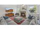 Comfortable living room with a brick fireplace, large windows, and stylish decor, creating a cozy atmosphere at 2090 Bellavista St, Castle Rock, CO 80109