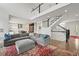 Open-concept living room with a staircase, high ceilings, and stylish decor, creating a spacious and inviting area at 2090 Bellavista St, Castle Rock, CO 80109