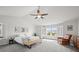 Large main bedroom with a ceiling fan, bright windows with privacy shutters, and neutral-colored carpet at 2090 Bellavista St, Castle Rock, CO 80109