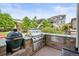 Built-in outdoor kitchen featuring granite countertops, a grill, and a smoker in a serene backyard setting at 2090 Bellavista St, Castle Rock, CO 80109