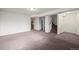 Spacious carpeted basement leading to stairs and washer and dryer at 11651 Pennsylvania St, Northglenn, CO 80233