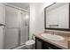 Bathroom featuring shower with sliding glass door, modern vanity and large mirror at 11651 Pennsylvania St, Northglenn, CO 80233