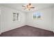 Bedroom with neutral carpet, a ceiling fan, and two bright windows at 11651 Pennsylvania St, Northglenn, CO 80233