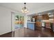 Open kitchen and dining area with hardwood floors, stainless appliances, and sliding doors to a patio at 11651 Pennsylvania St, Northglenn, CO 80233