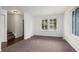 Bright living room featuring neutral carpet, windows with blinds, and an open floor plan to the entryway at 11651 Pennsylvania St, Northglenn, CO 80233