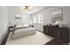 Stylized main bedroom boasts a neutral color palette, plush carpet, a ceiling fan, and ample natural light at 11651 Pennsylvania St, Northglenn, CO 80233
