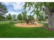 A vibrant neighborhood playground with colorful equipment and a lush green lawn at 11651 Pennsylvania St, Northglenn, CO 80233