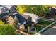 An aerial view of a modern home featuring a covered porch with a stone and dark gray siding at 516 Grant Ave, Louisville, CO 80027