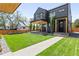 Beautifully landscaped backyard featuring a modern home with a covered patio at 516 Grant Ave, Louisville, CO 80027
