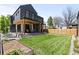 Beautiful backyard featuring a covered patio and lush green lawn at 516 Grant Ave, Louisville, CO 80027