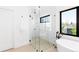 Elegant bathroom featuring a glass-enclosed shower, soaking tub, and stylish black fixtures at 516 Grant Ave, Louisville, CO 80027